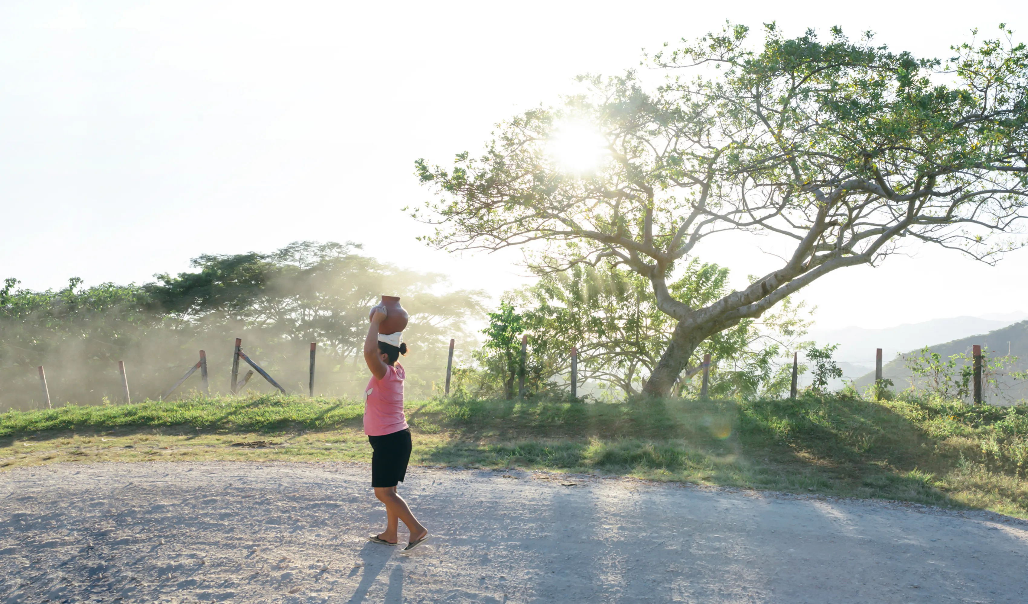 Woman carries a water vessel in Honduras