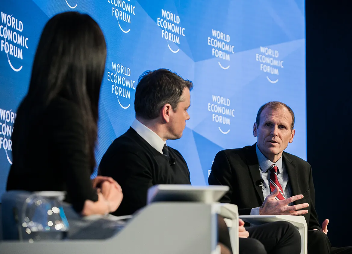 Water.org co-founders speaking on a panel at the World Economic Forum.