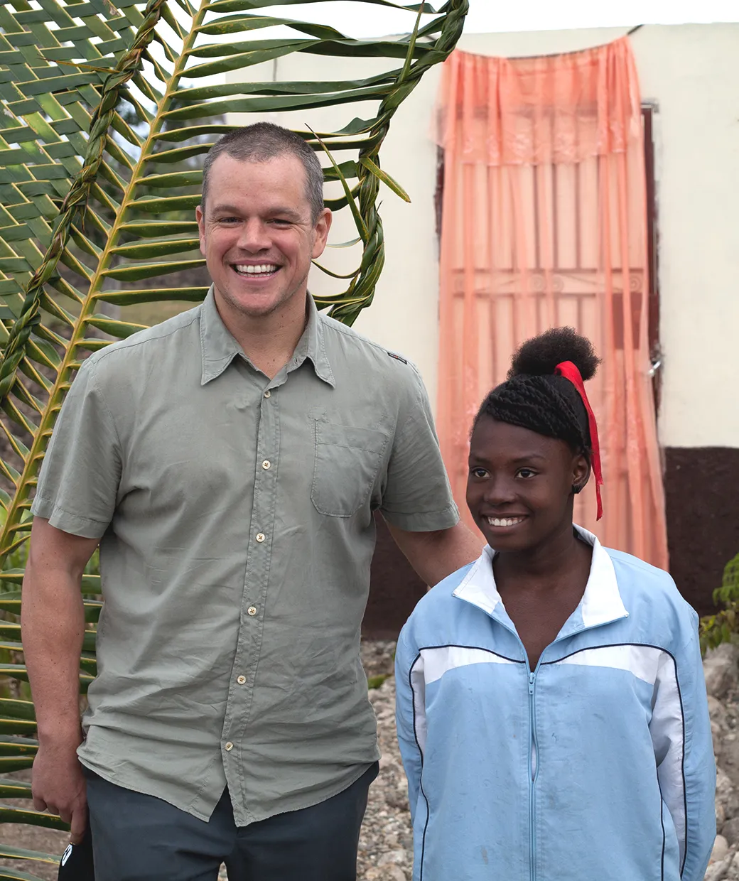 Water.org co-founder Matt Damon poses with young woman in Africa.