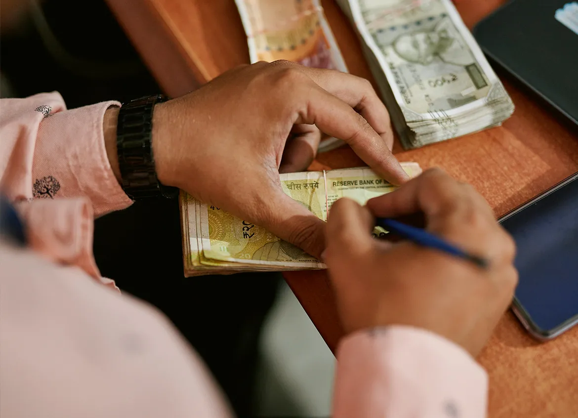 An employee at a bank handles money.