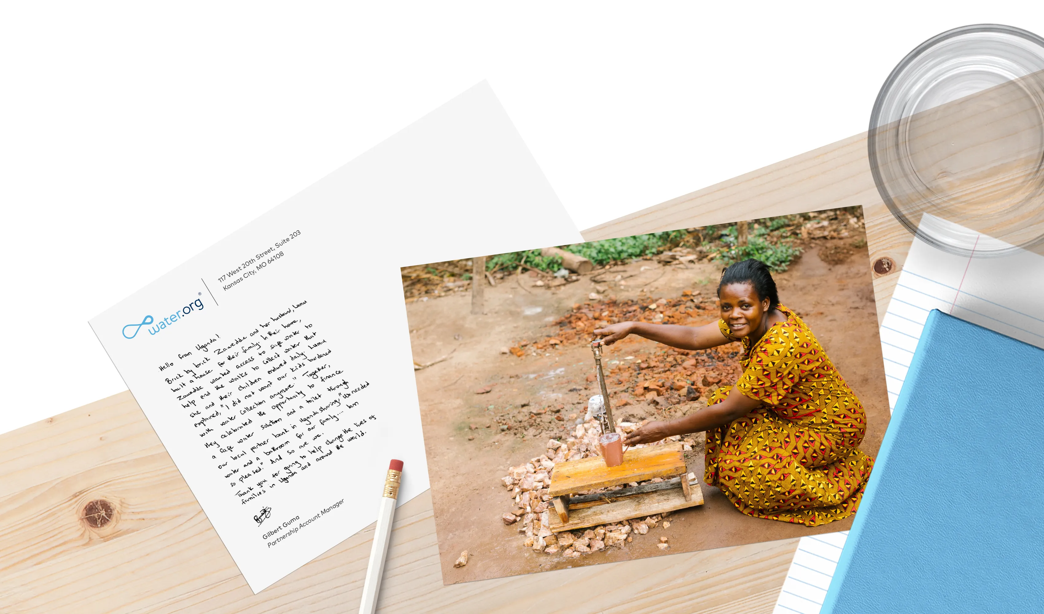 A postcard with an image of Lumiu sitting on a table next to a blue journal, white pencil, and a glass of water