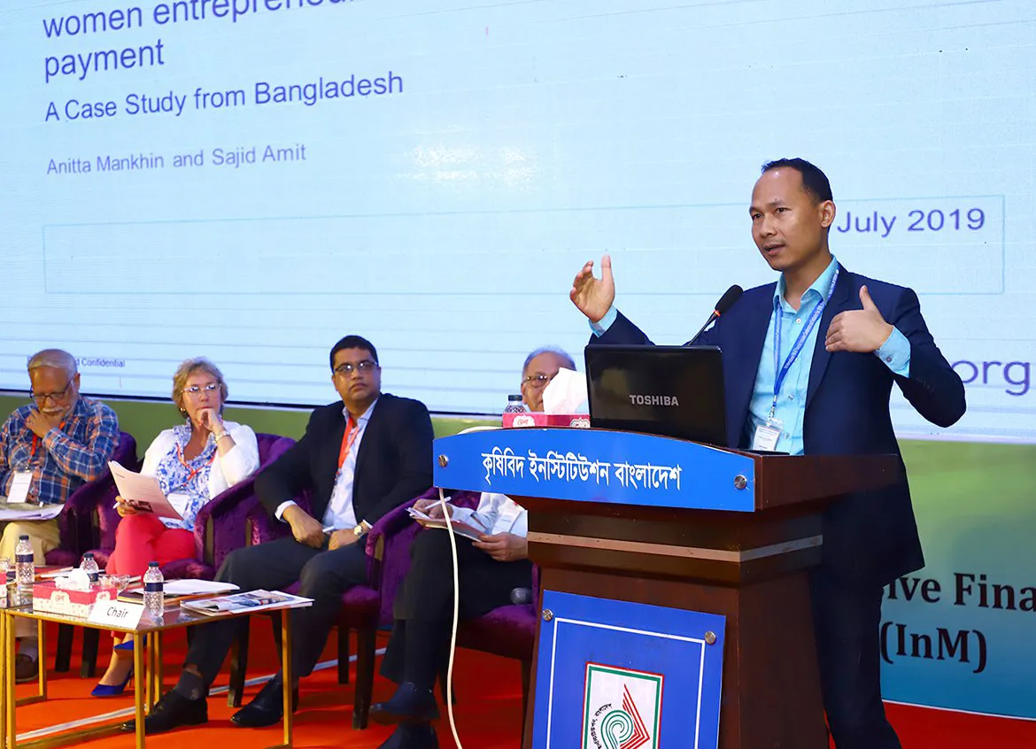 Team members speak on a panel at a financial inclusion conference in Dhaka, Bangladesh.