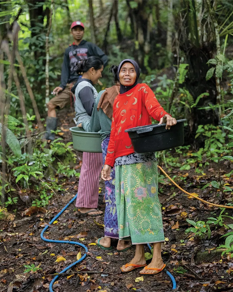 Family carrying buckets on their way to retrieve water.