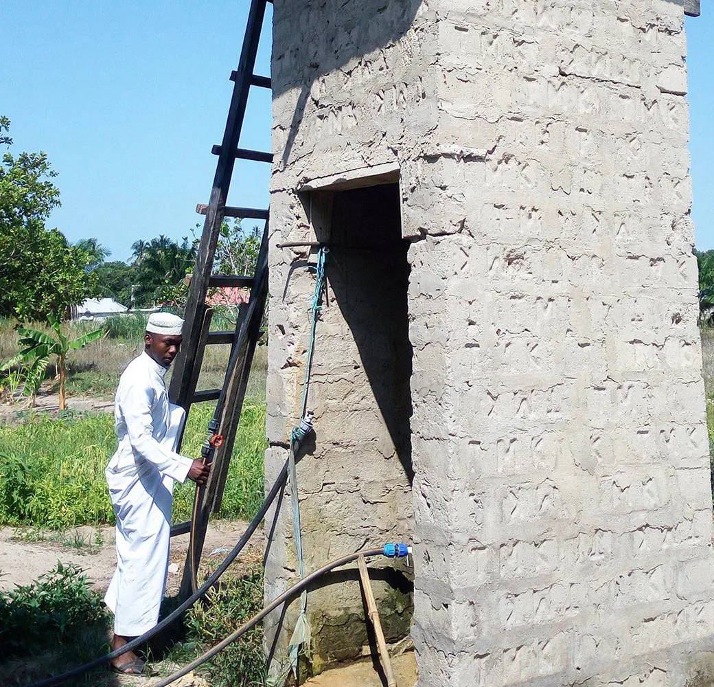 A man accessing a safe water source in Tanzania.