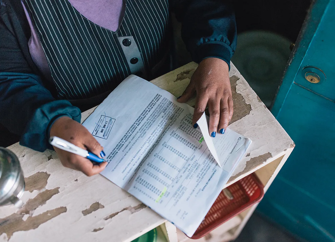 Woman looking through financial documents.