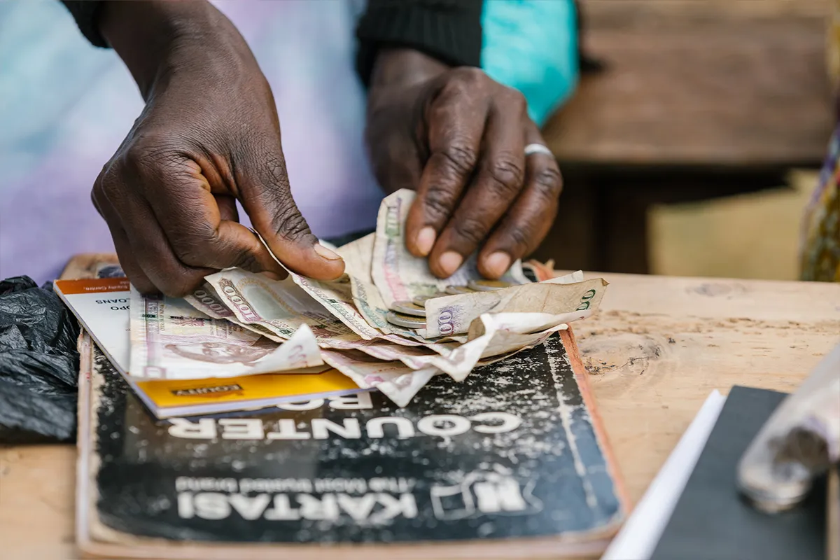 Woman counting Kenyan shillings.