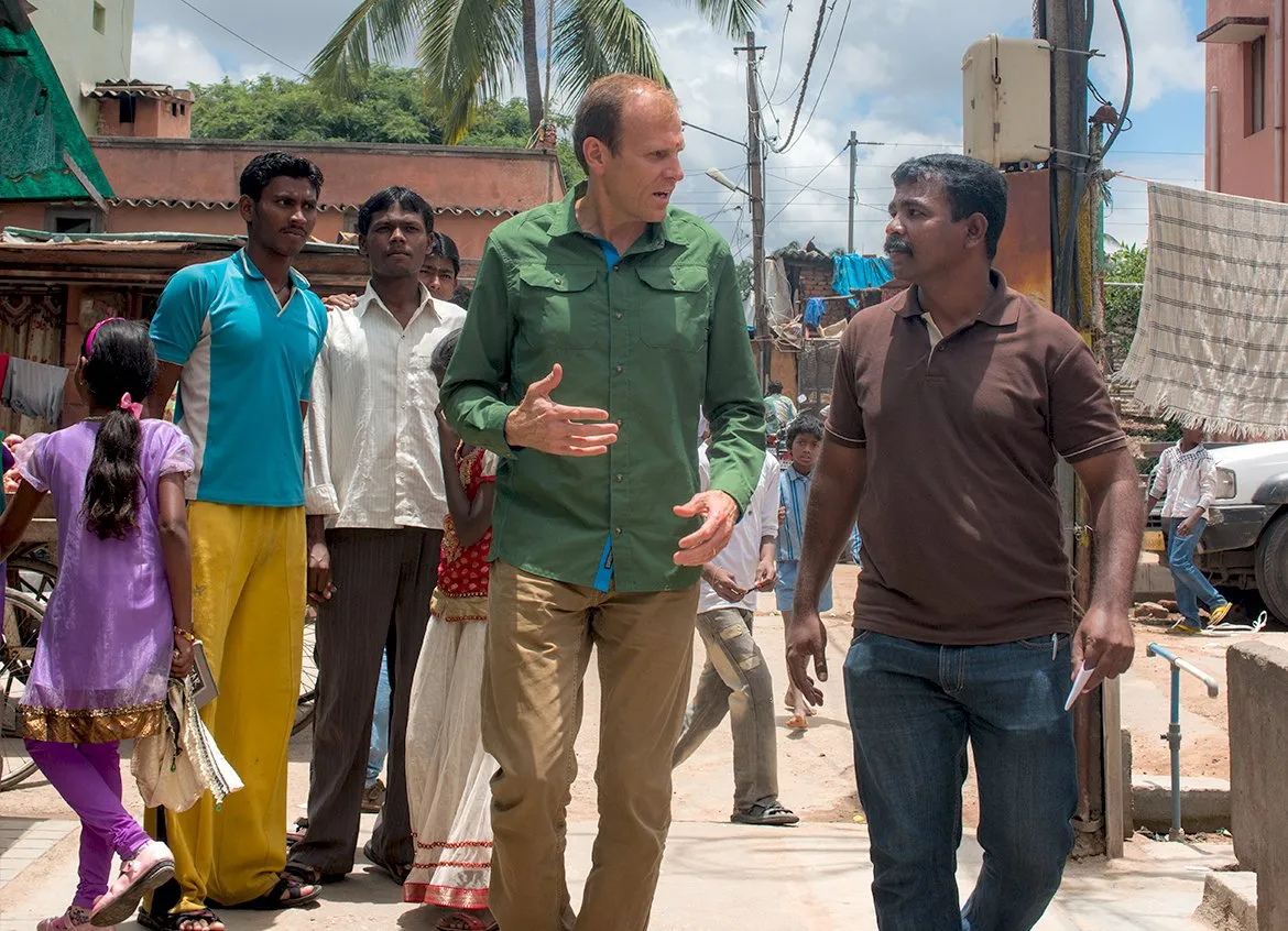 Water.org Co-founder Gary White speaking to a man in India.